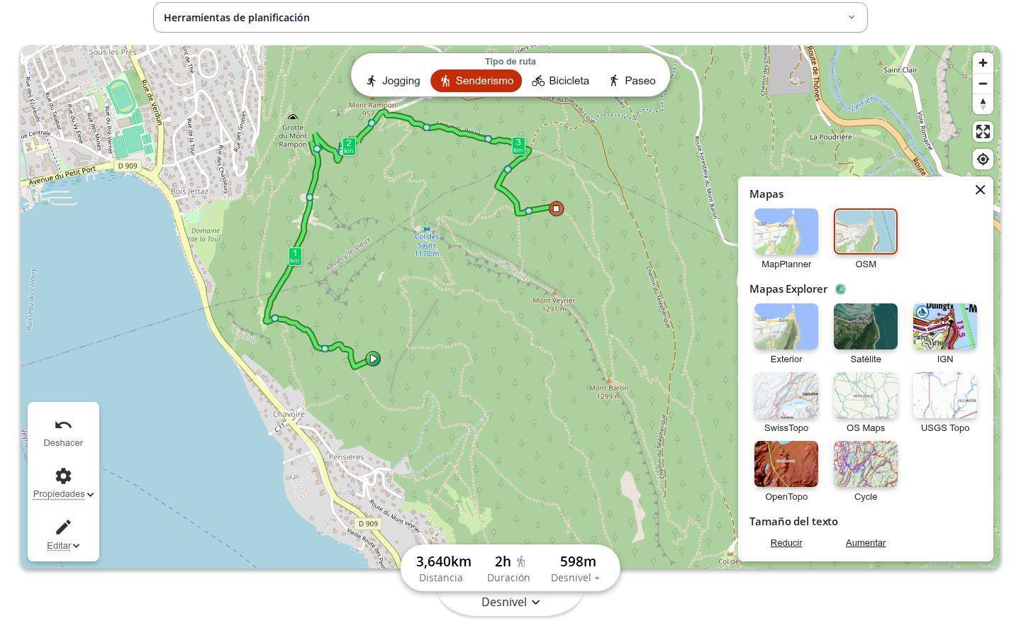 Planificador de MapPlanner en un ordenador con el panel de mapas abierto: miniaturas de MapPlanner y OSM, después Exterior, Satélite, IGN, SwissTopo, OS Maps, USGS Topo, OpenTopo y Cycle reservados a la oferta Explorer, junto al ajuste del tamaño del texto